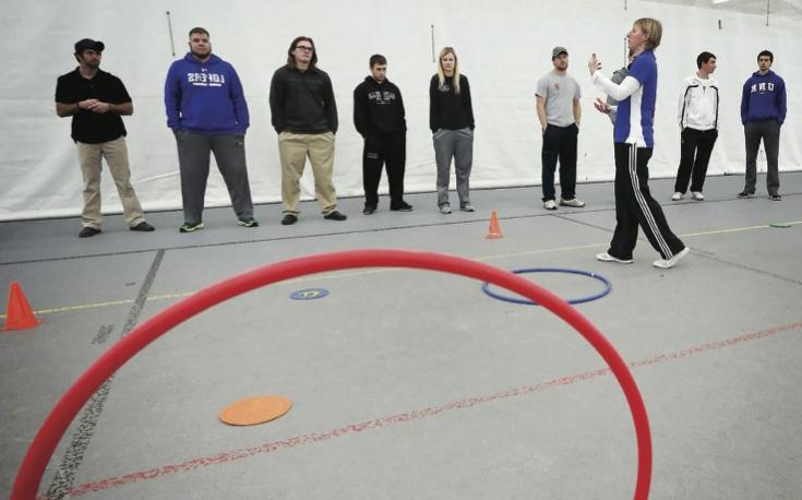 Teacher and students in a gym